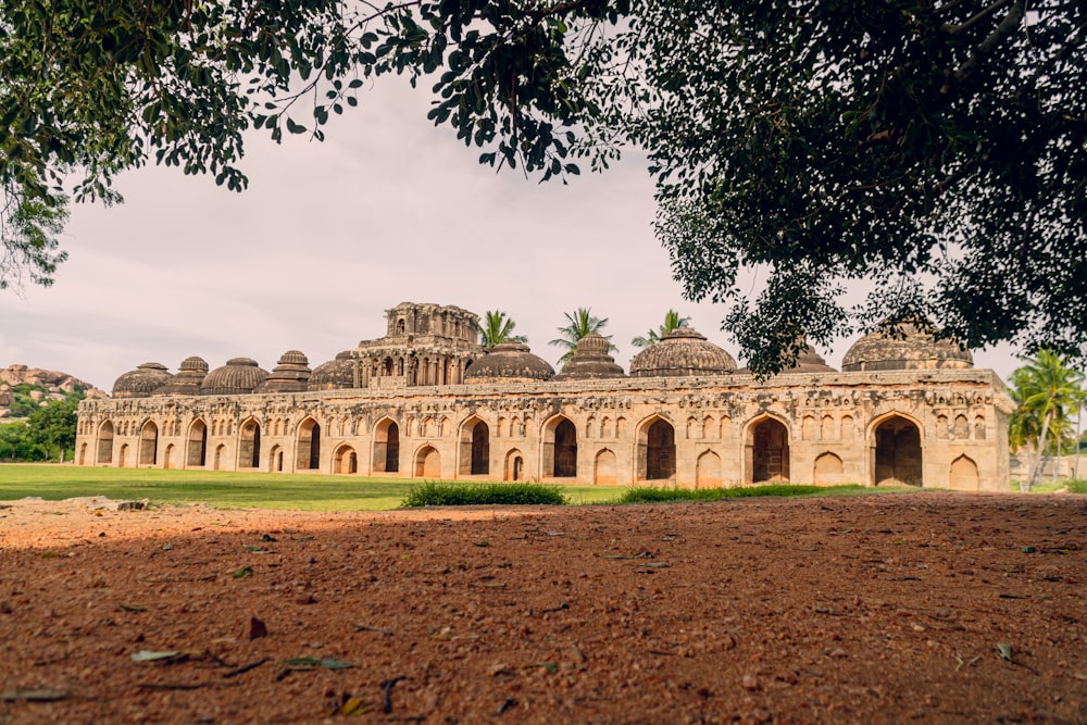 a large building sitting on top of a lush green field