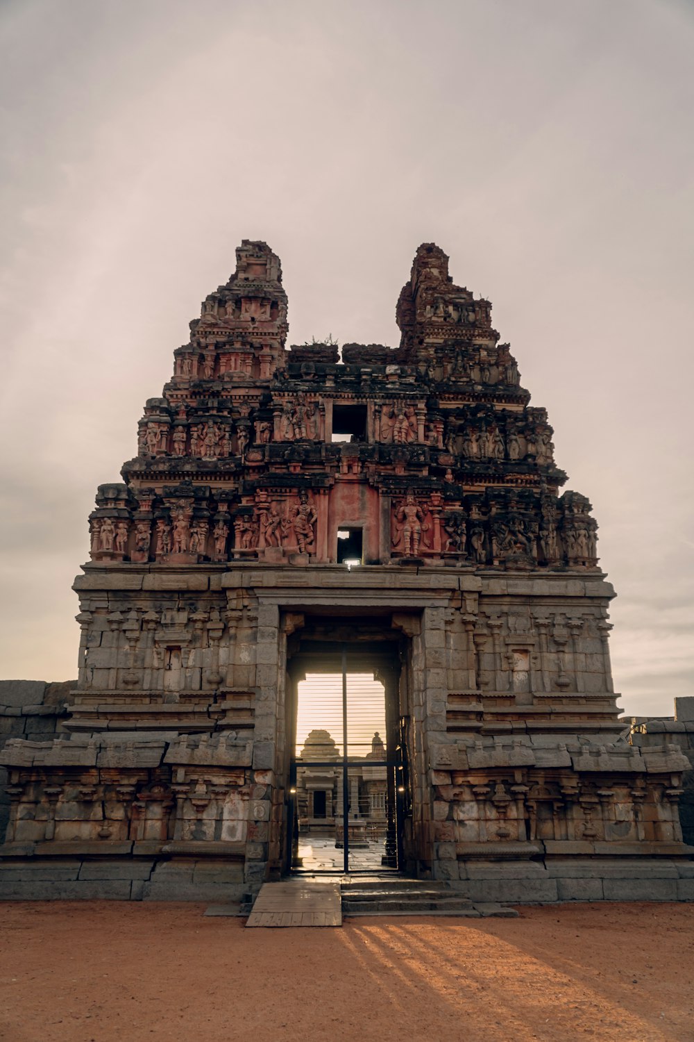 the entrance to a large stone structure with statues on it