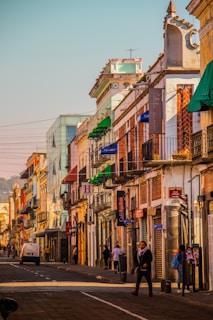 A vibrant street scene in Nagpur showcasing local shops and residential buildings bathed in warm sunlight.