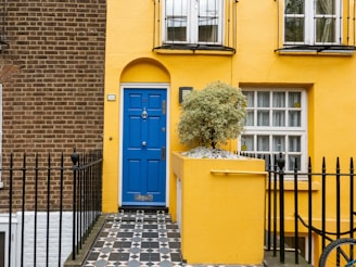 Finished blue and yellow painted house showcasing custom design and quality craftsmanship