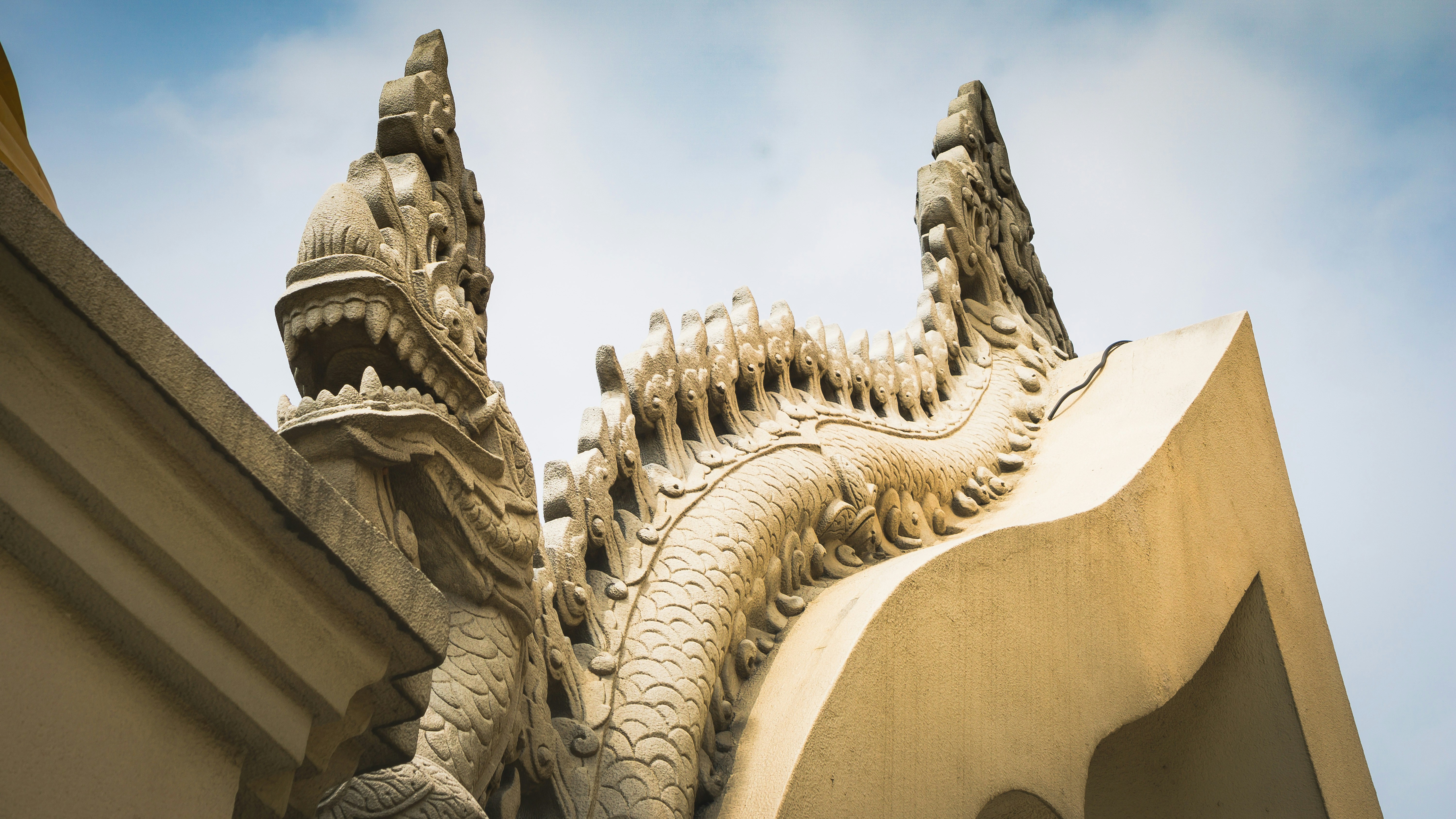 a close up of a dragon statue on a building