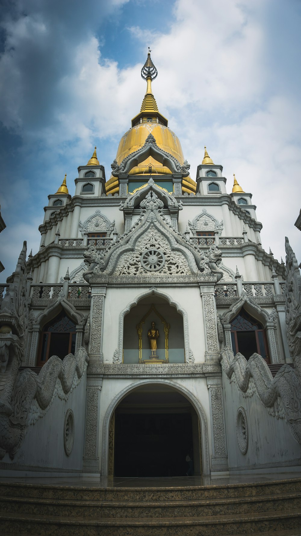 a large white building with a gold dome