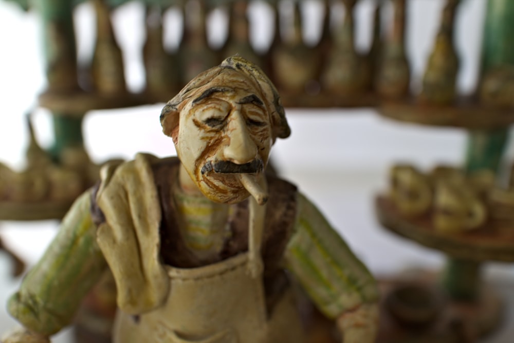 a ceramic figurine of a man with a mustache