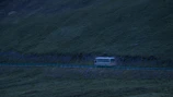 A sleek coach from Ember traveling through Edinburgh’s scenic outskirts.