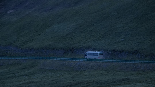 A bus traveling on a scenic highway.