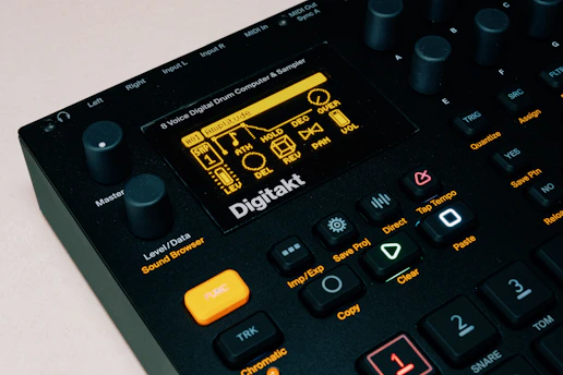 Close-up of a sleek Akai MPC Live III with custom Maschine Heads kit loaded on the screen.