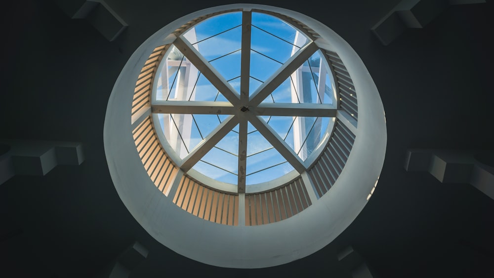 a round window with a skylight in the middle of it