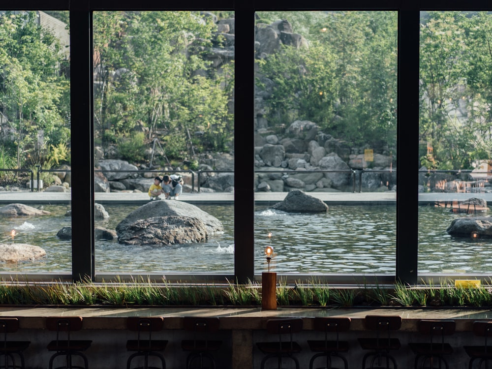 a view of a pond through three windows