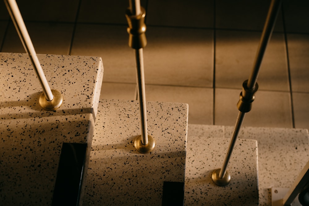 a close up of a number of poles on a tiled floor