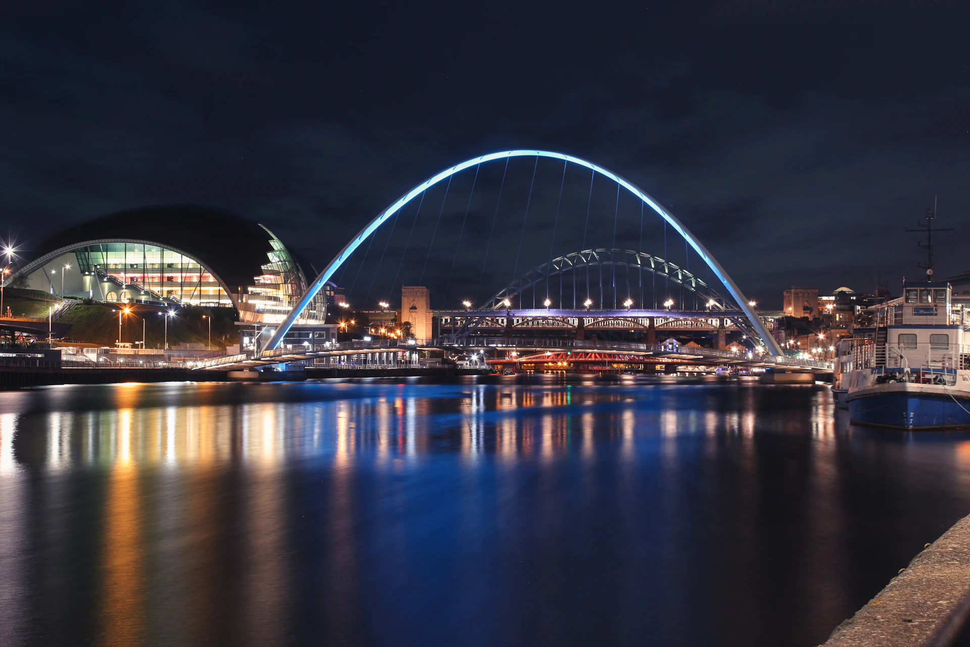 a bridge over a body of water at night