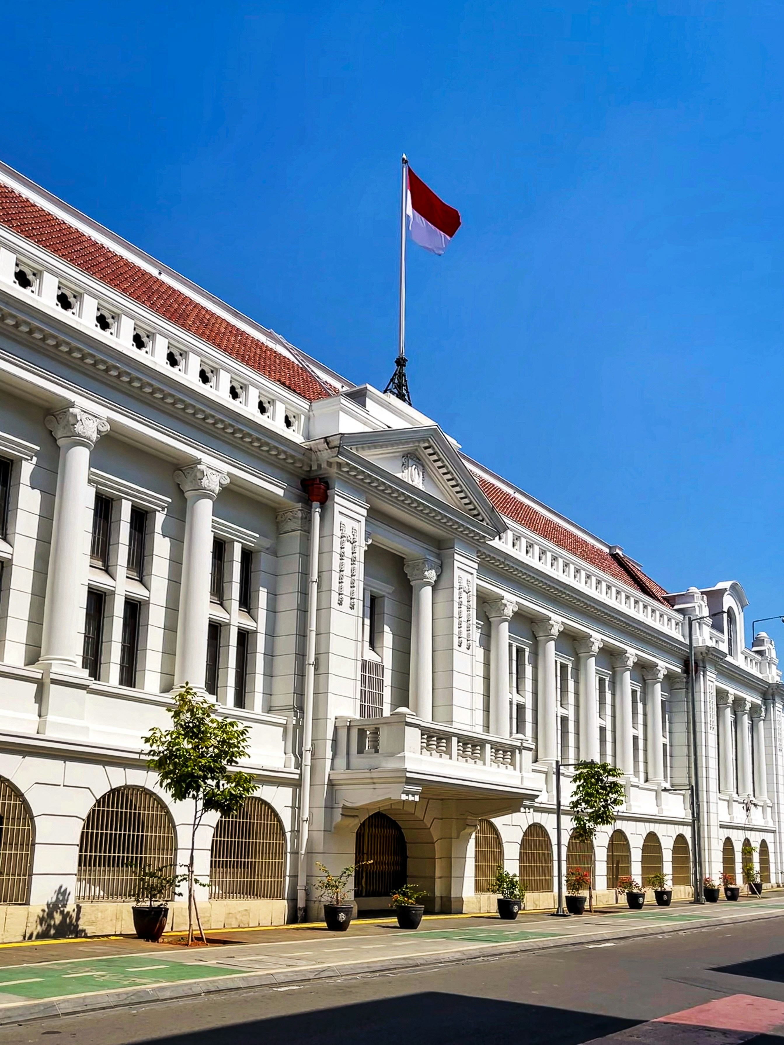 a large white building with a flag on top of it