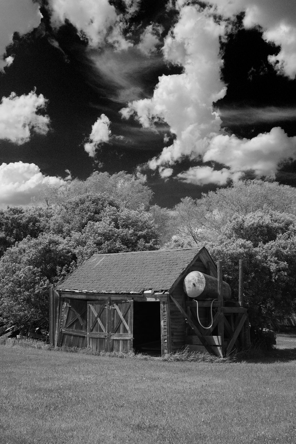 a black and white photo of a barn