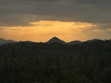 Sunset view from the bungalow porch with mountains in the background.