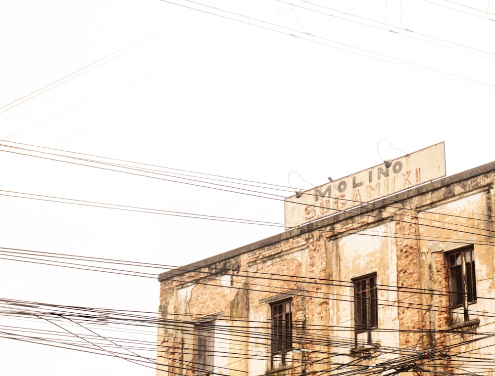 an old building with lots of power lines in front of it
