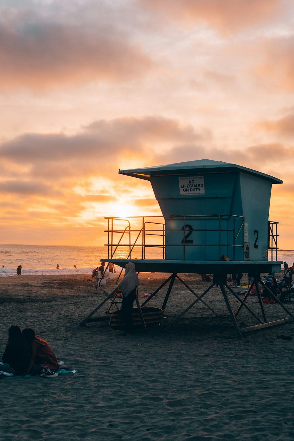 a lifeguard tower sitting on top of a sandy beach