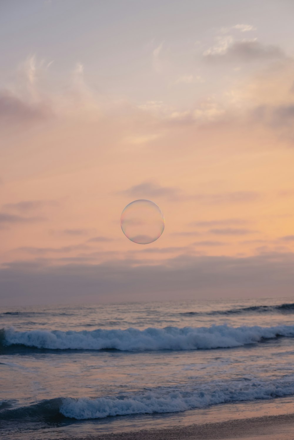 a person standing on a beach flying a kite