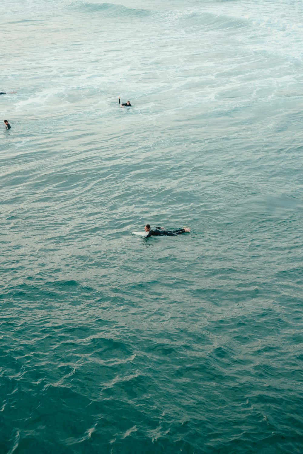 a group of people swimming in the ocean