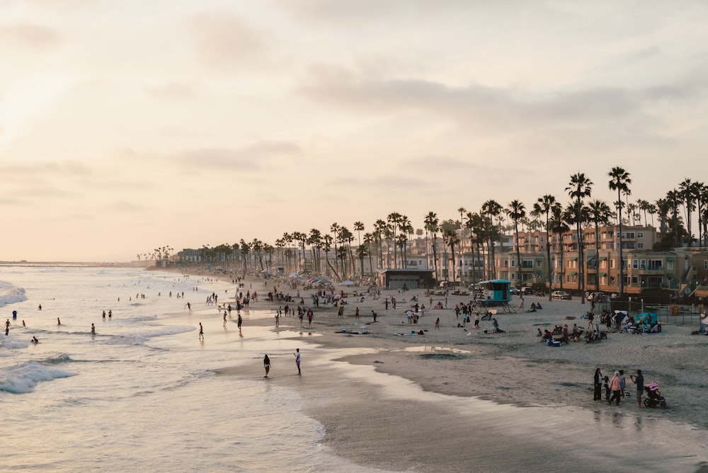 a crowded beach with people on the sand and in the water