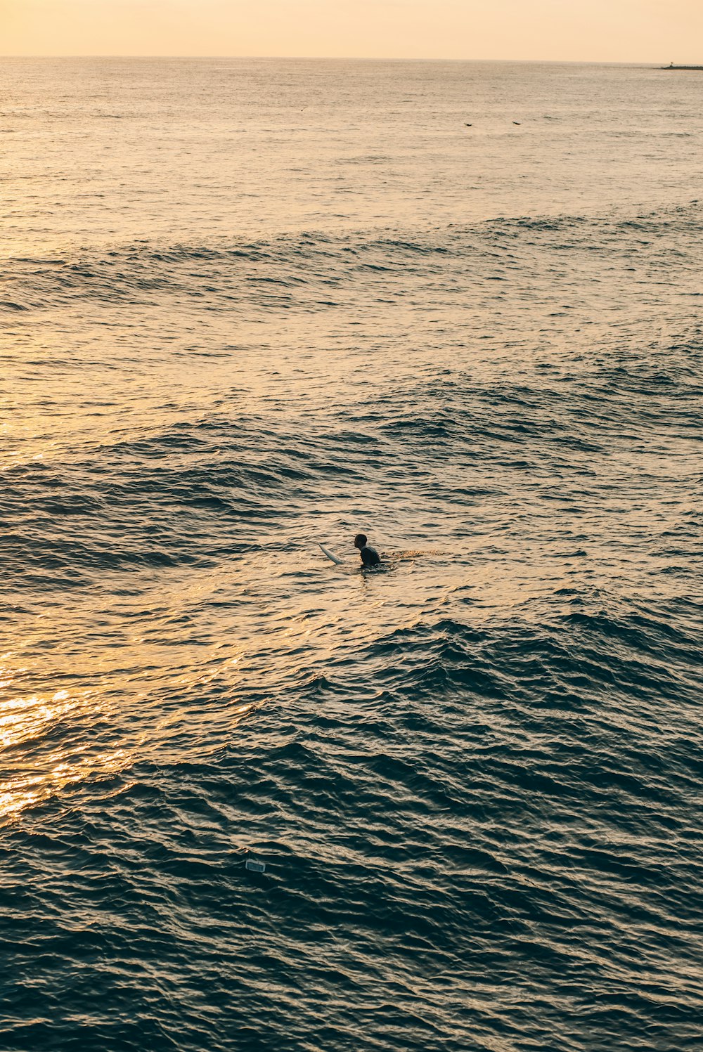 a person riding a surfboard on a wave in the ocean