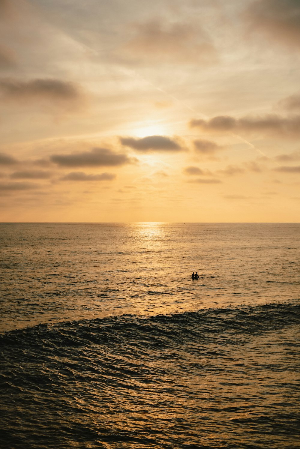 a person riding a surfboard on a wave in the ocean