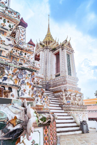 The majestic Badrinath temple framed by vibrant mountain flowers under a clear blue sky.