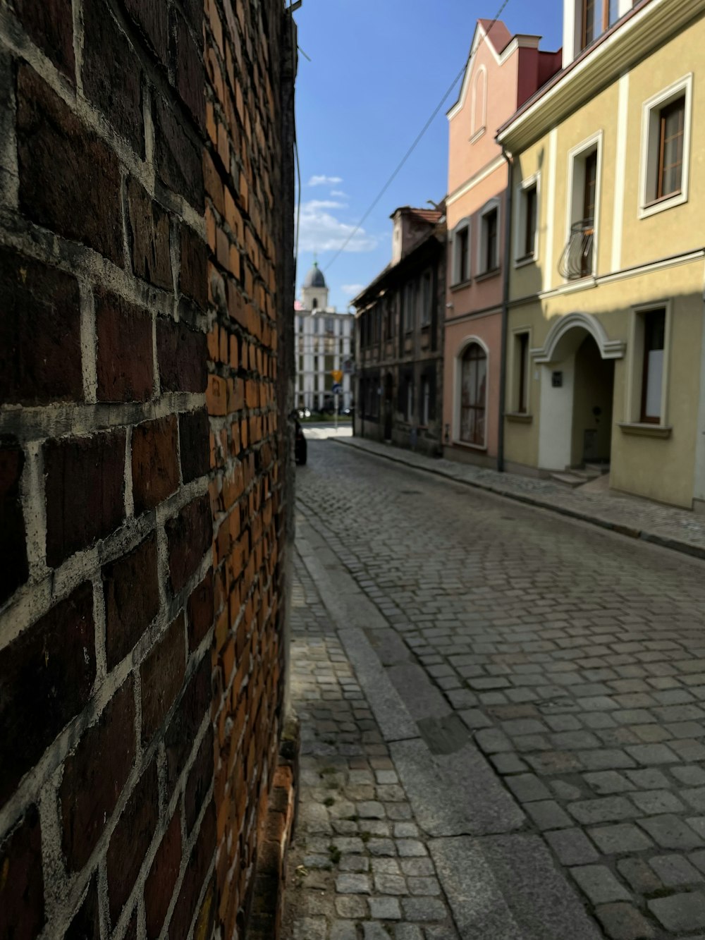 a brick wall on the side of a street