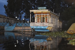 An elegant houseboat exterior glowing at sunset on calm water.