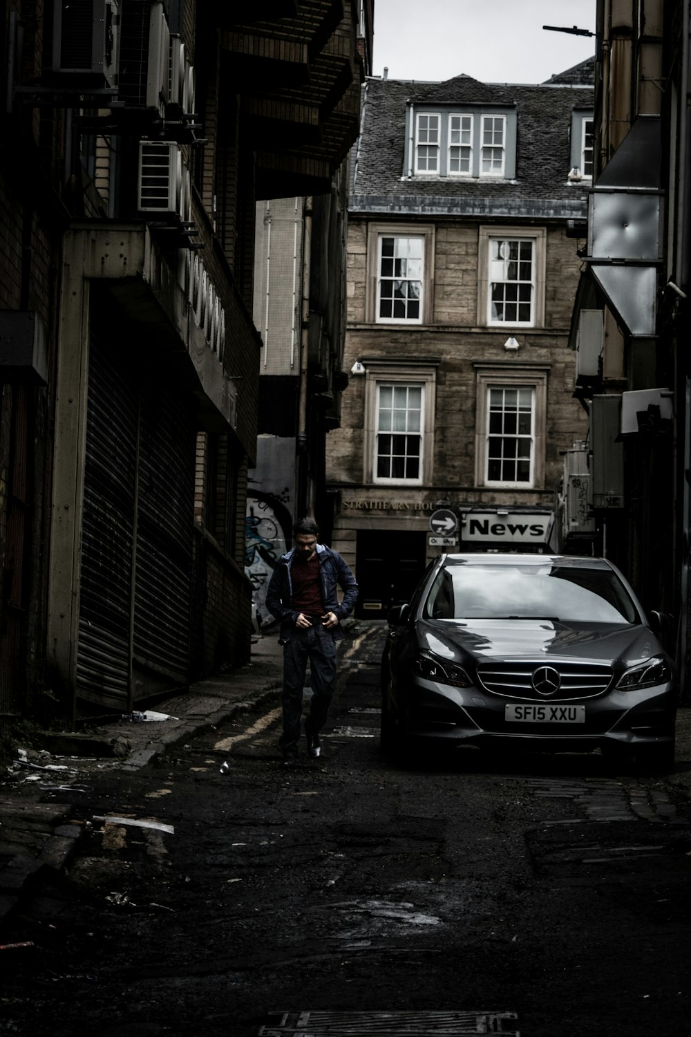 a car parked on the side of a street next to a building