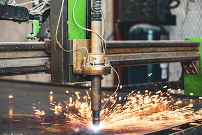 a machine cutting a piece of metal with sparks