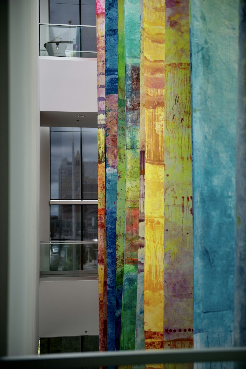 a multicolored curtain hanging in front of a window