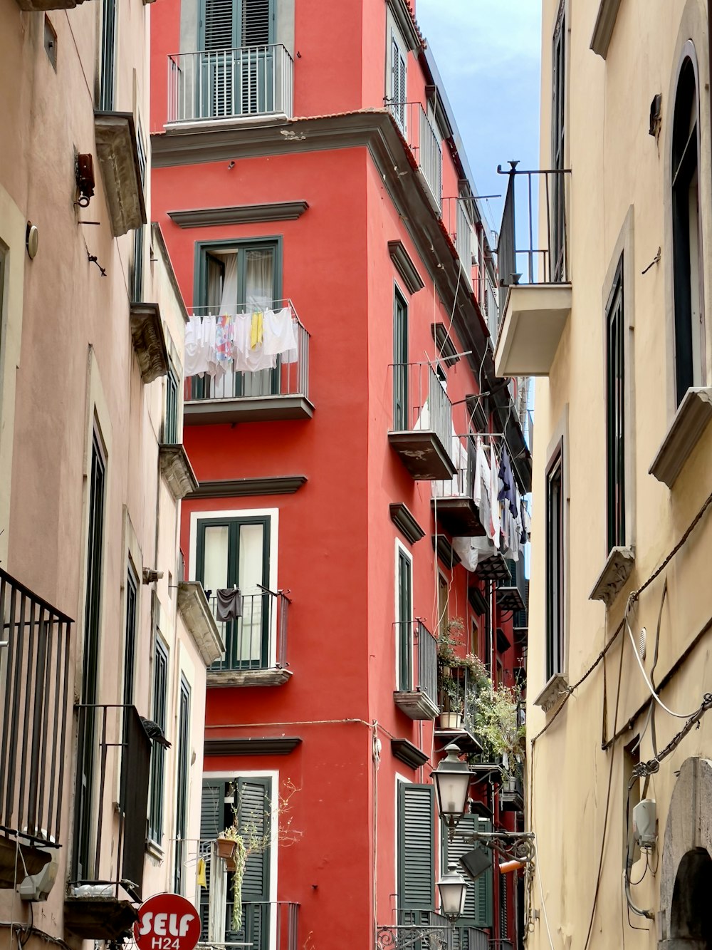 a red building with balconies and balconies on the balconies