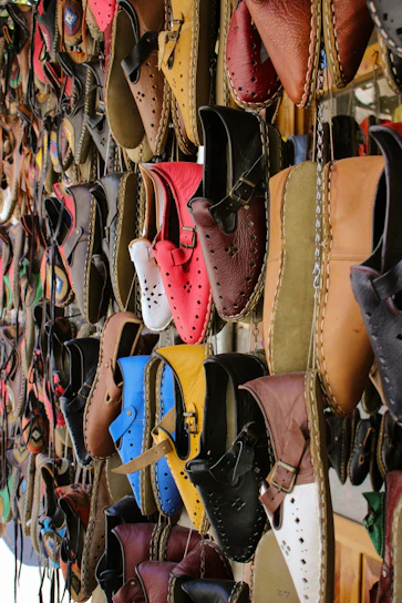 a bunch of shoes that are hanging on a wall