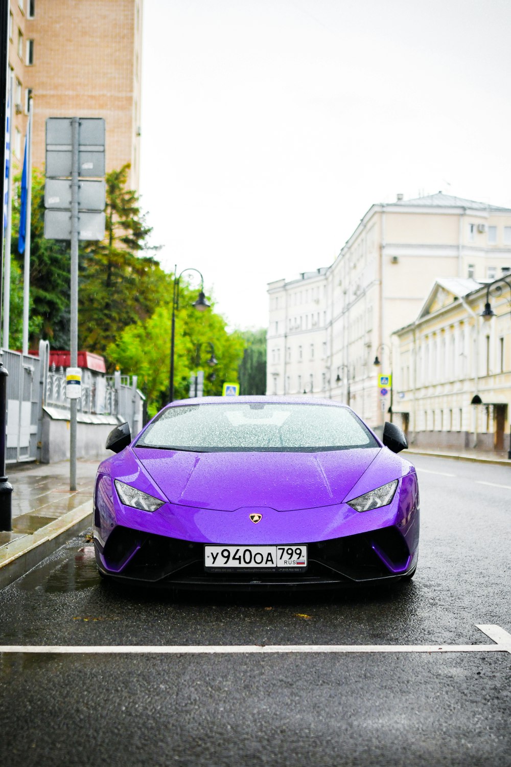 a purple sports car parked on the side of the road