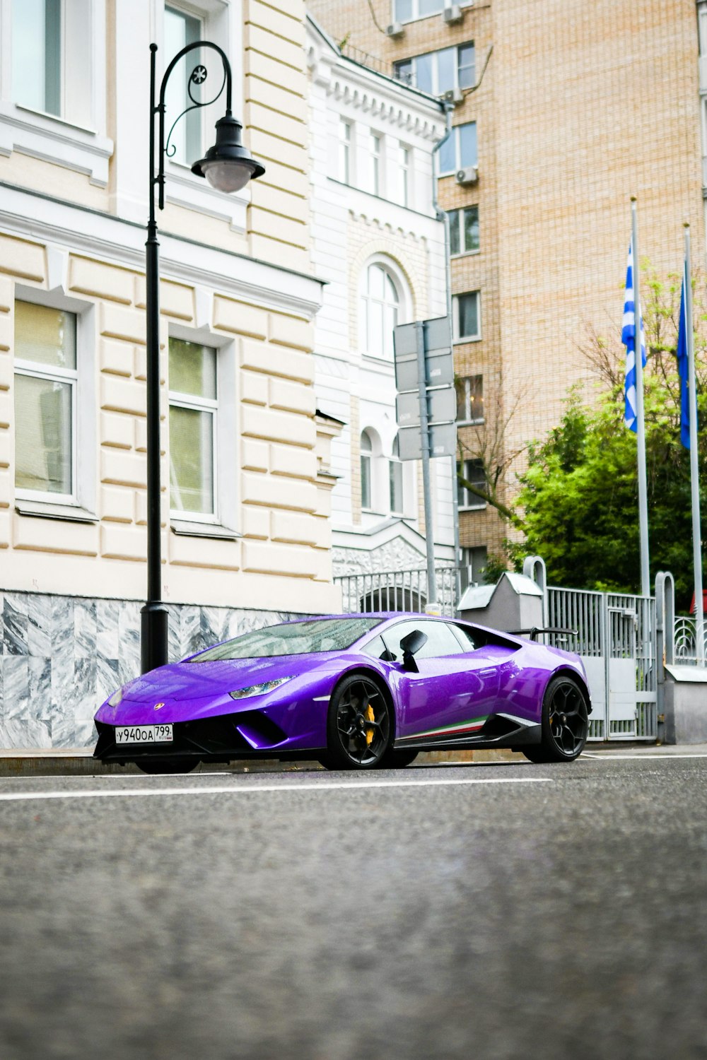 a purple sports car parked on the side of the road