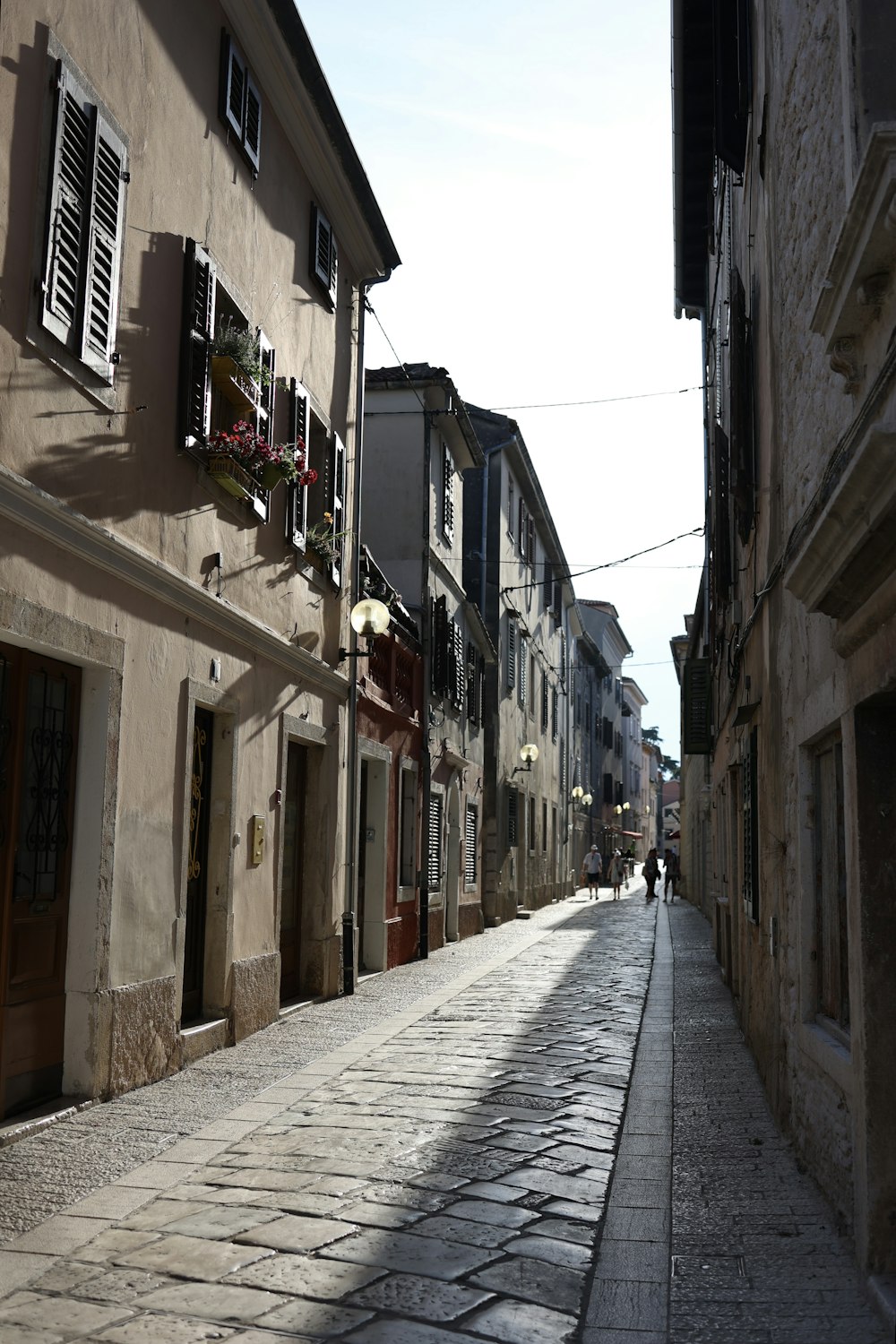 a cobblestone street lined with old buildings