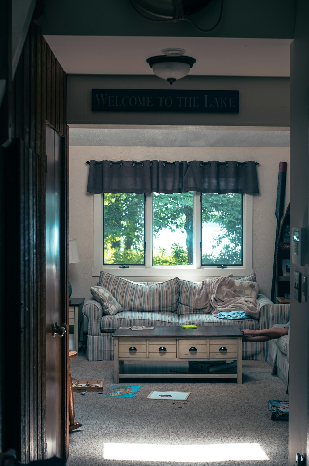 a living room filled with furniture and a window