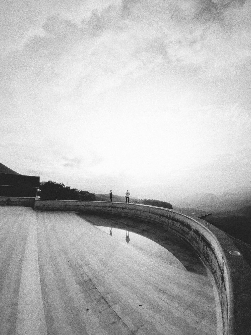 a black and white photo of a person on a skateboard