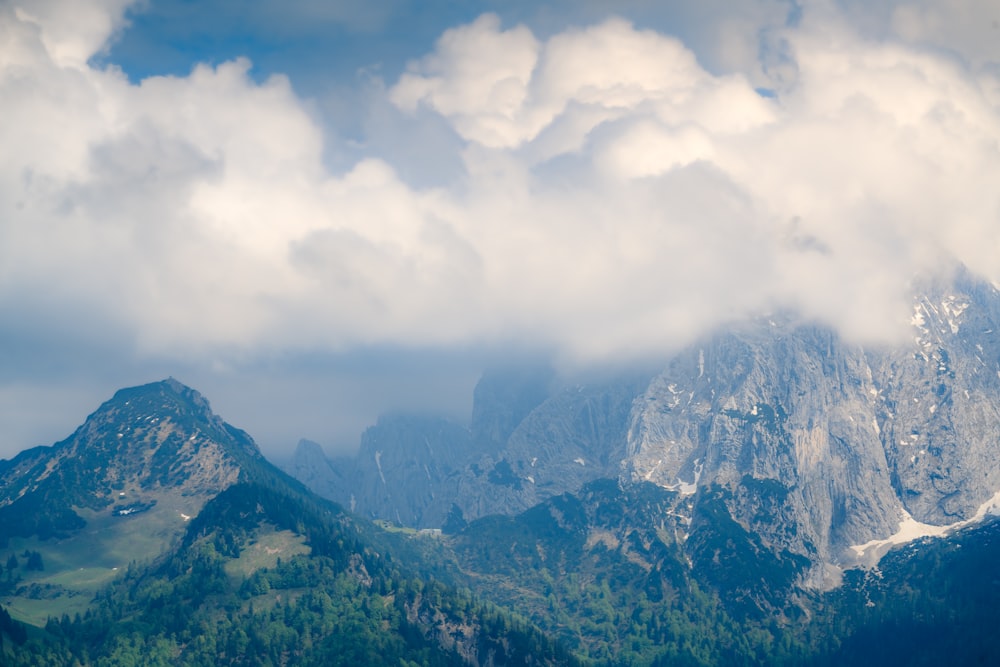 a view of a mountain range with clouds in the sky