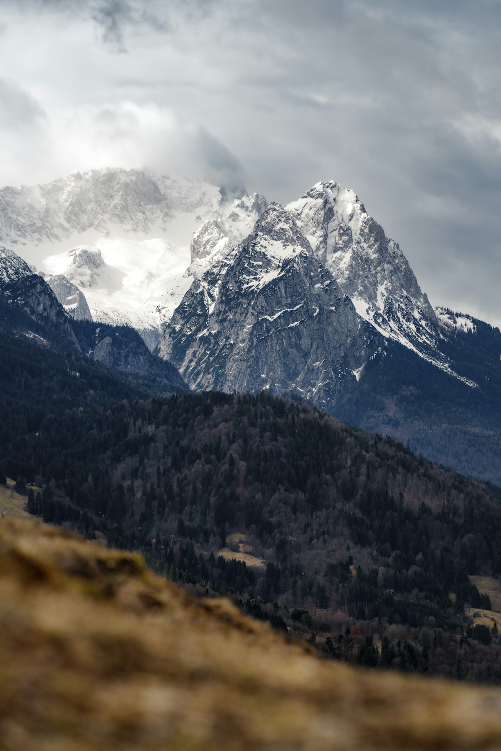 a mountain range with snow capped mountains in the background