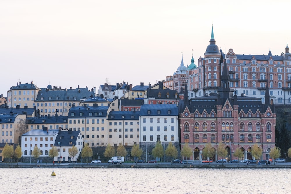 a group of buildings next to a body of water