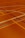 A floor is covered with intersecting lines of varying colors, including orange, blue, and dark brown. These lines form geometric shapes such as rectangles and curves, creating a visually striking pattern.