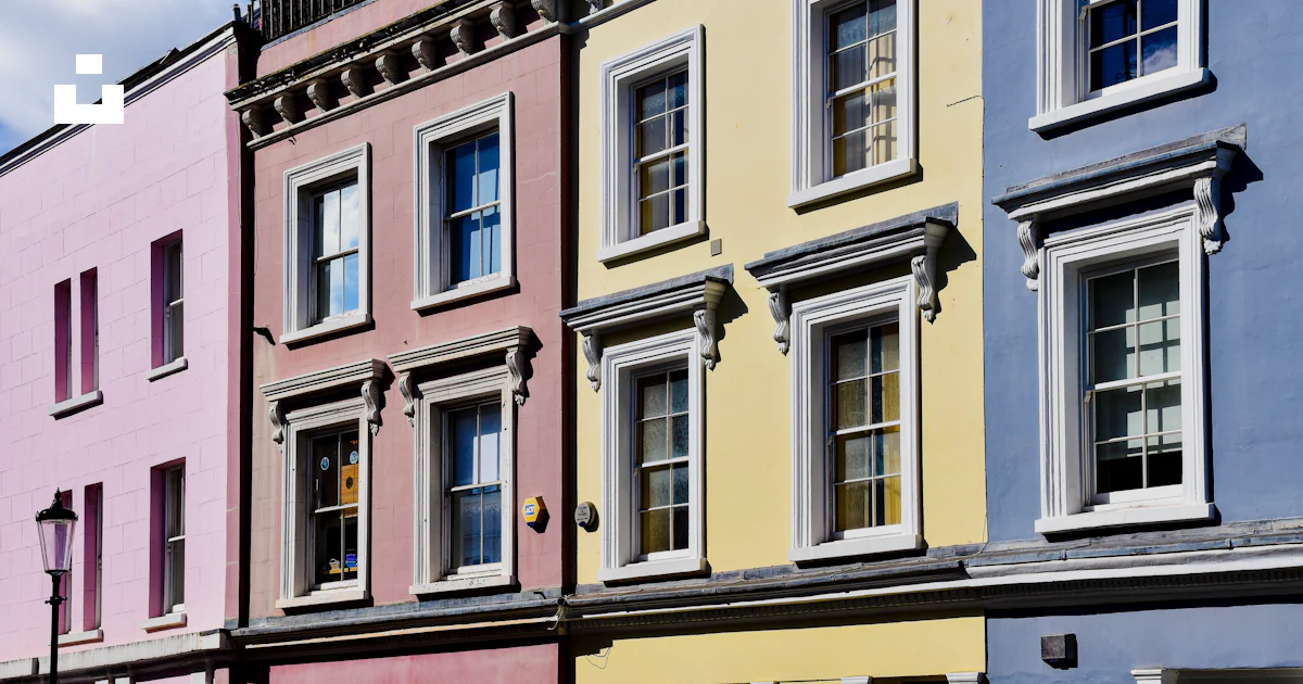 Multiple Color Building A row of multi - colored buildings with a blue sky in the background ...