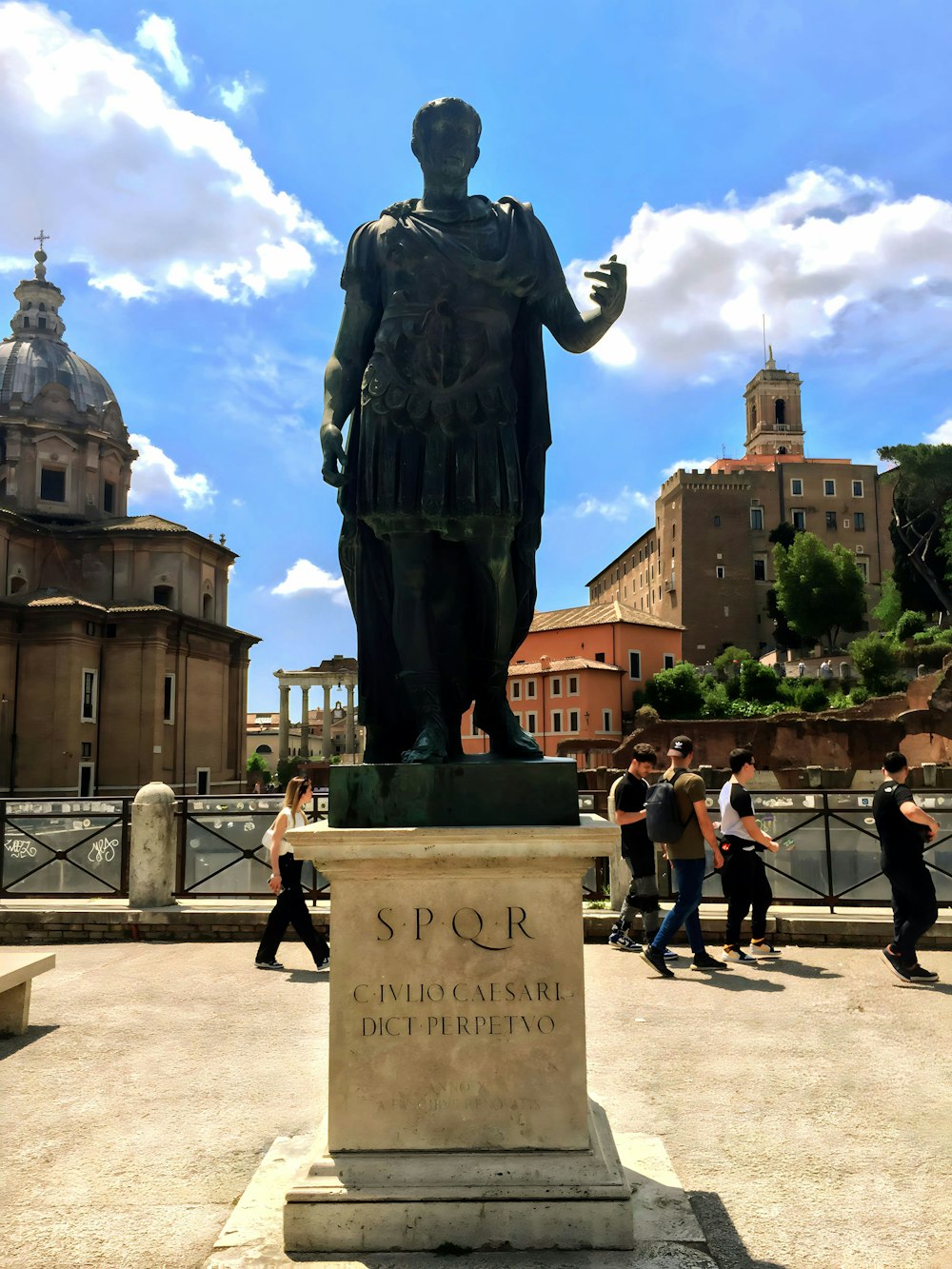 a statue of a man with a hat and a cane