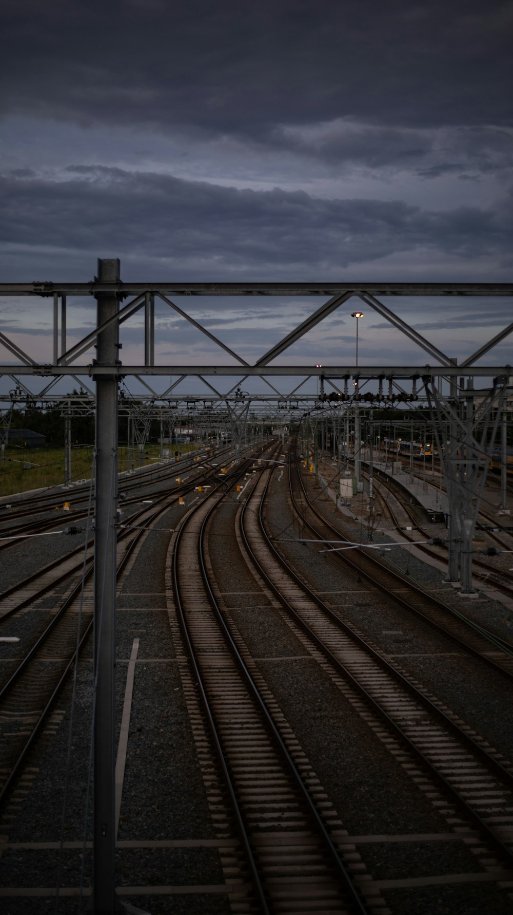 a train track with a dark sky in the background