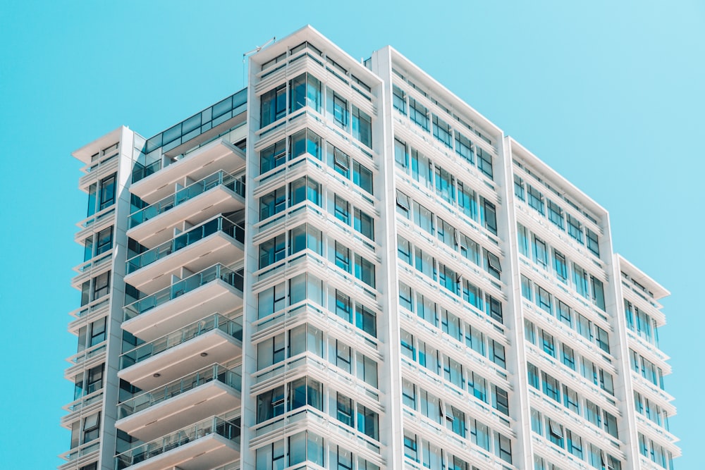 a tall white building with balconies and balconies