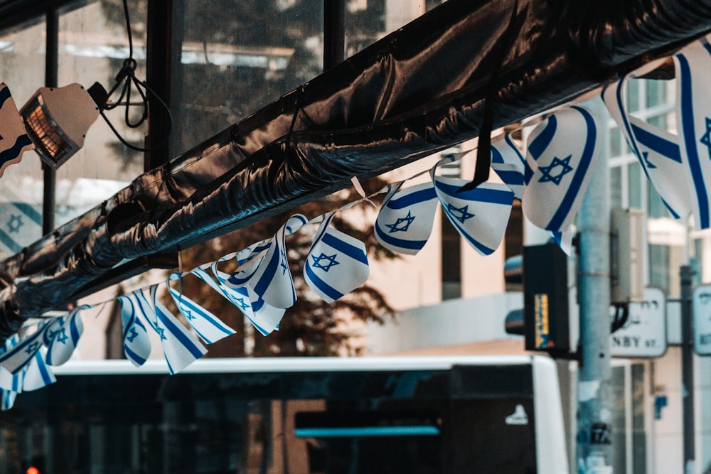 a bunch of blue and white flags hanging from the side of a building