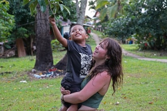 A young boy engaged in a playful physical therapy session with a caring therapist.