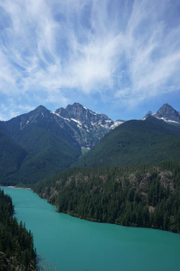 Crystal-clear waters of Morskie Oko framed by rugged mountain peaks under a dramatic sky.
