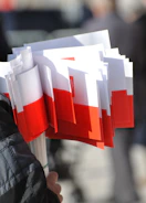 a person holding a bunch of red and white papers