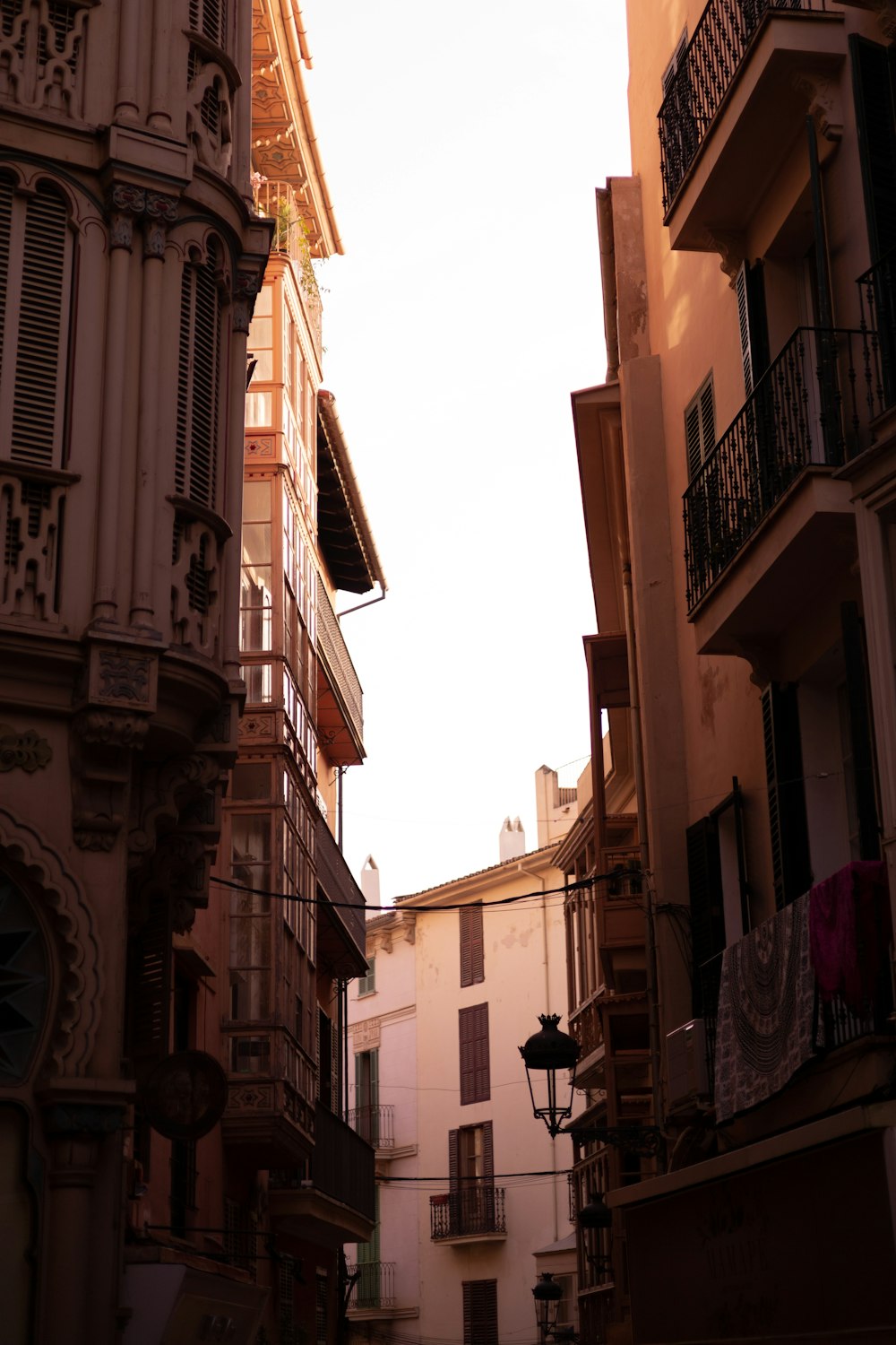 a narrow street with buildings and balconies